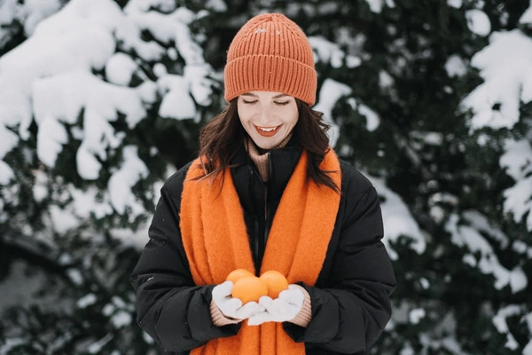 woman-holding-citrus-fruits-snow-600nw-2531798347